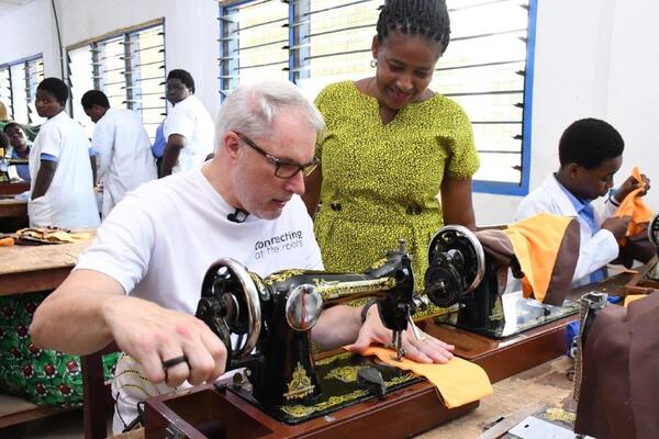 Stephen Blewett, CEO of MTN Ghana sewing a school uniform during the 2025 21 Days of Y'ello Care